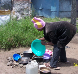 Jerusha washing dishes outside her home